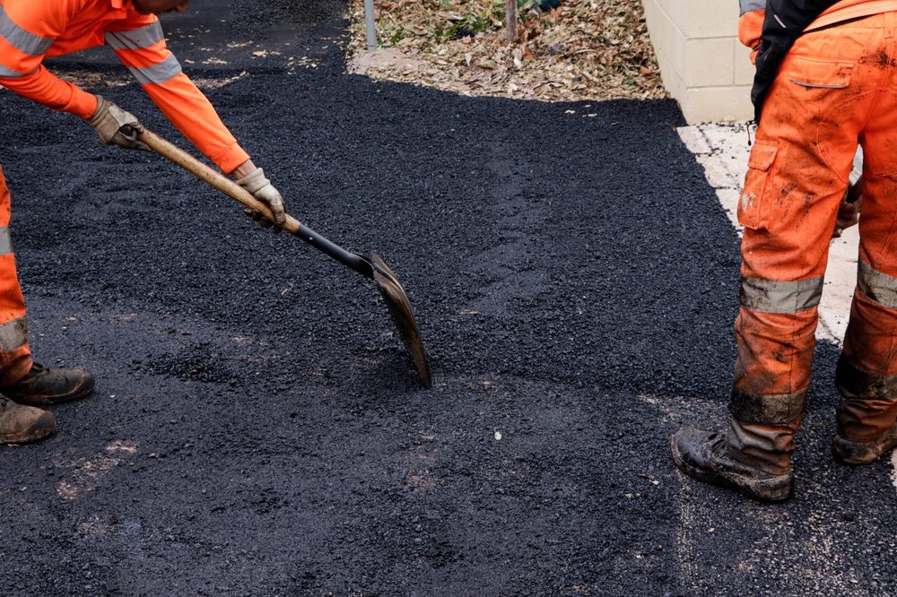How to Choose the Right Asphalt Repair Service for Your Ottawa Home. workers repairing holes in the street.