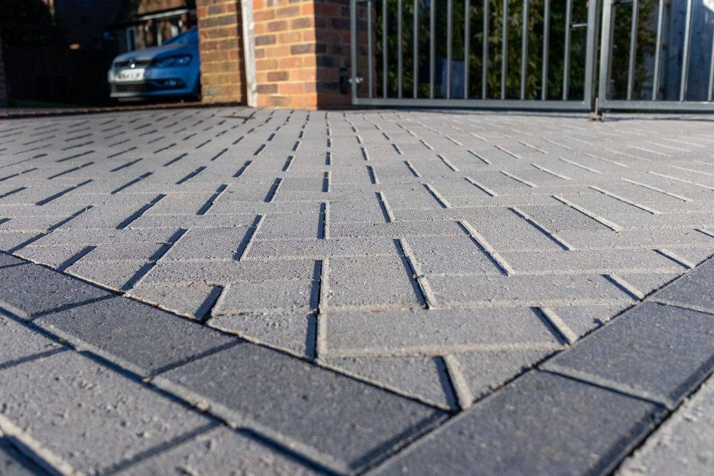 Comparing Popular Interlock Patterns for Residential Driveways: Pros & Cons. Low-angle close-up of a block-paved driveway.